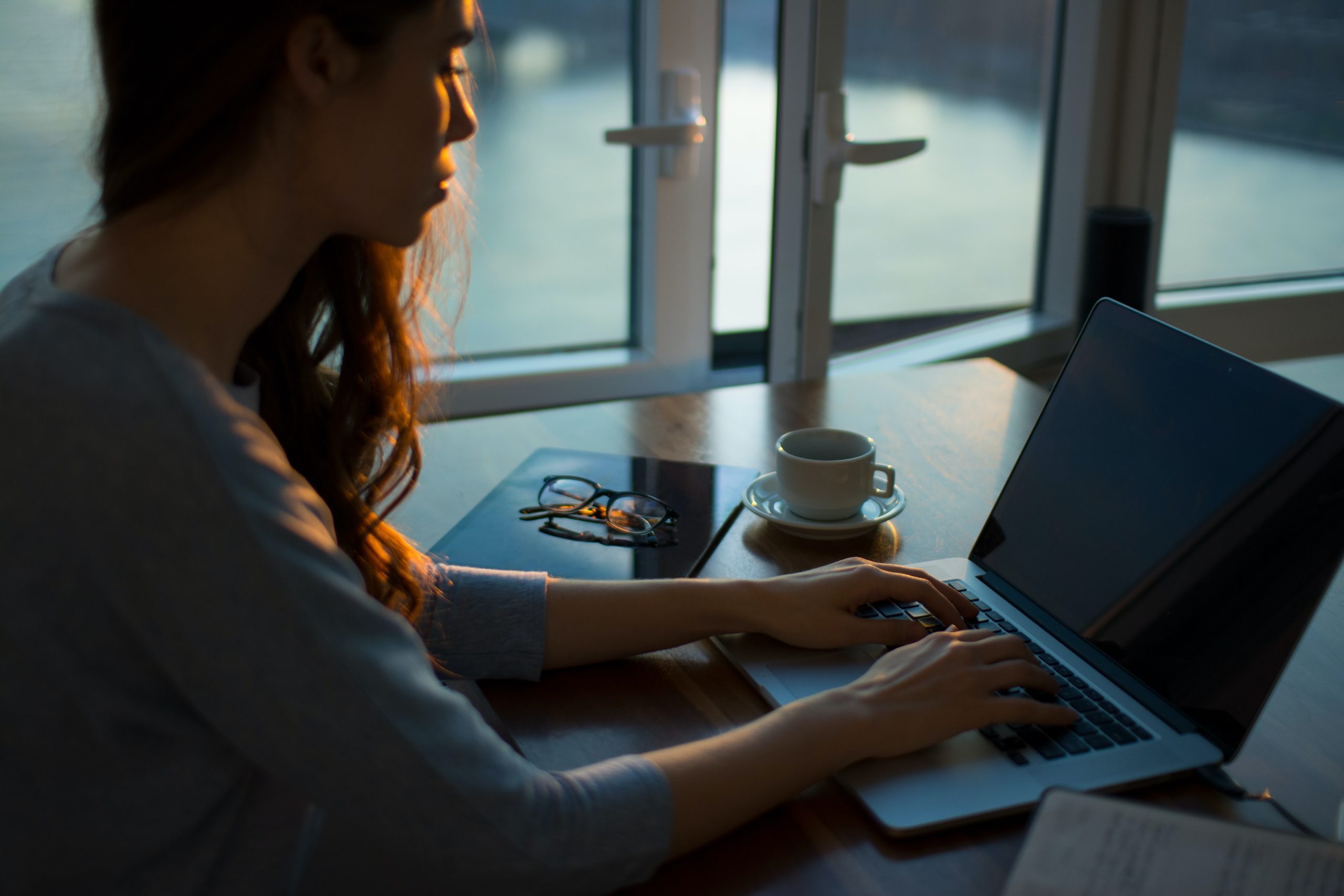 An image of a person typing on a computer.