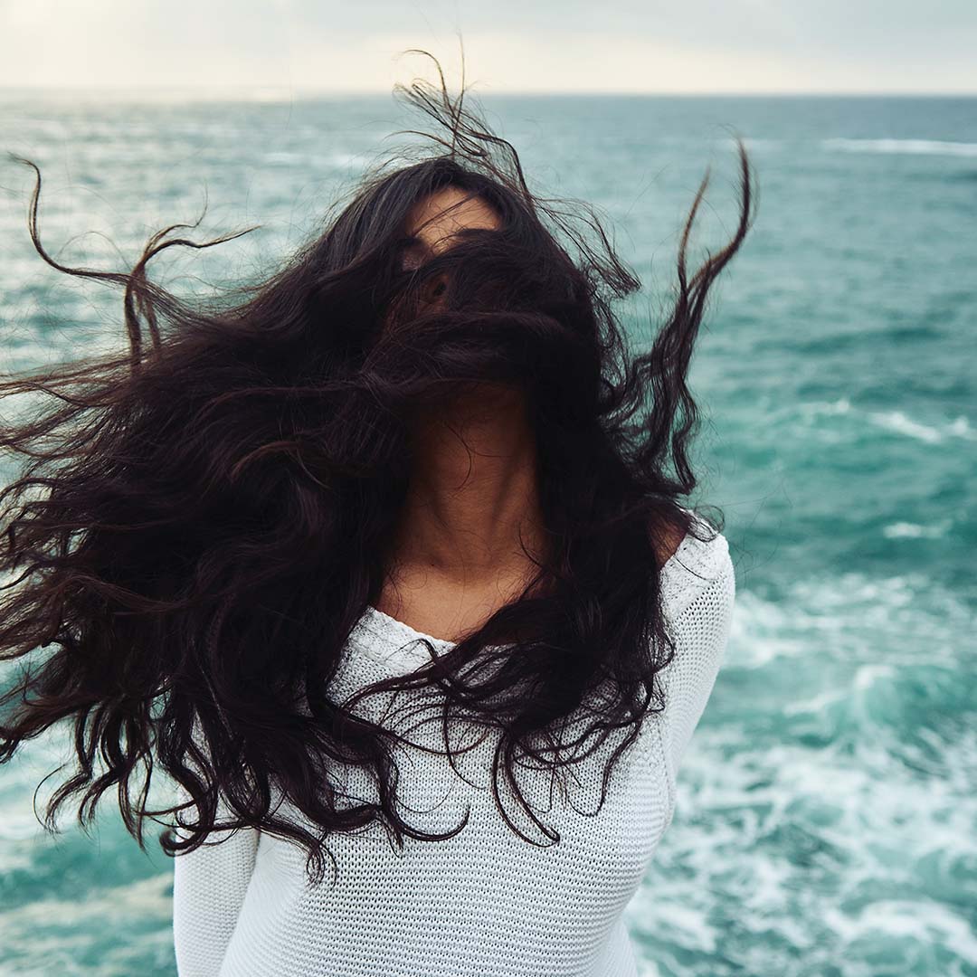 Woman with beautiful hair next to ocean
