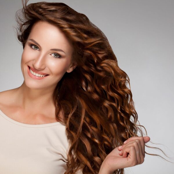 a woman smiling with curly hair