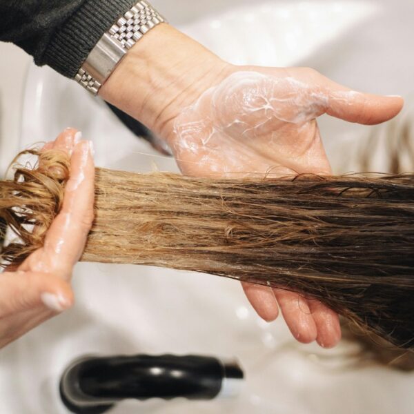 washing a wig in a sink